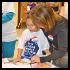 marilyn perlyn assists child with new braille book