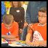 students read new books at ocho braille book fair
