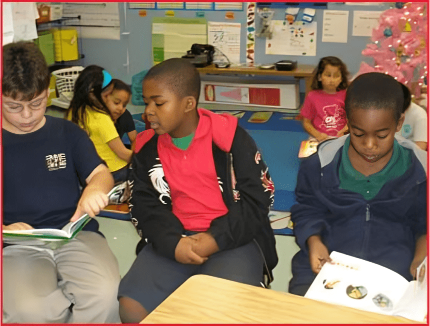 A group of children sitting in front of a table.