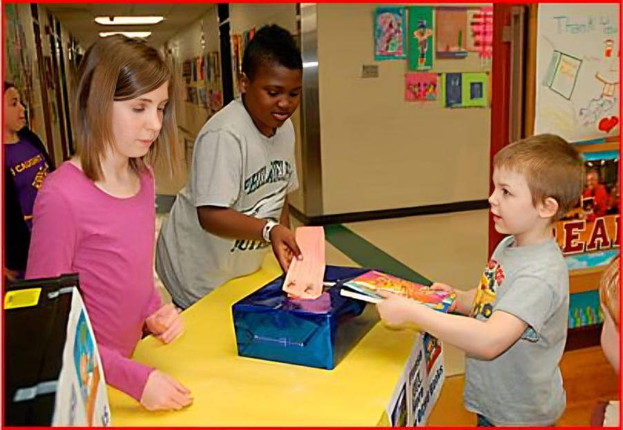 A group of kids standing around a table.