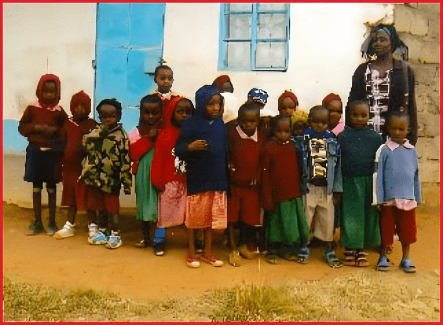 A group of children standing in front of a building.