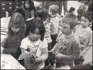 A group of children standing around each other.